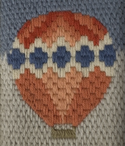 Bargello needlepoint in pinks and blue showing gentle rounded curves