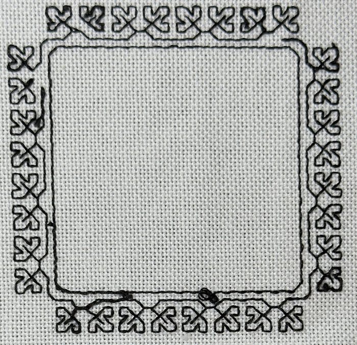The back of the same square border blackwork project. The pattern reads almost identically to the front, with a small knot visible on the bottom border