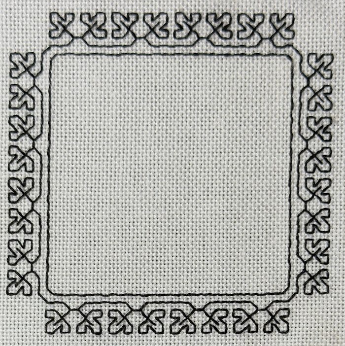 The front of the square border project from Blackwork for Beginners, a geometric blackwork border worked in black thread on cream evenweave fabric