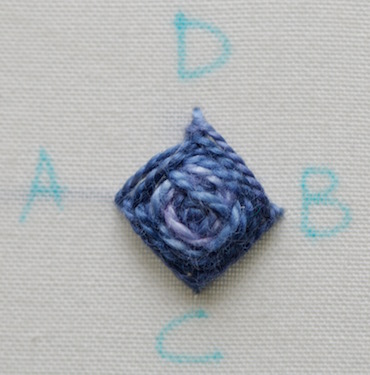 Photo 7 shows the completed raised buttonhole stitch flower worked in pearl cotton Photo 7 shows the completed raised buttonhole stitch flower worked in pearl cotton