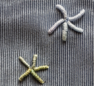 Bullion stitch used to create mini starfish motifs Bullion stitch used to create mini starfish motifs