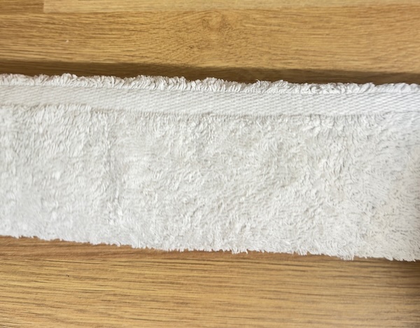 Cross stitch rolled up in towel