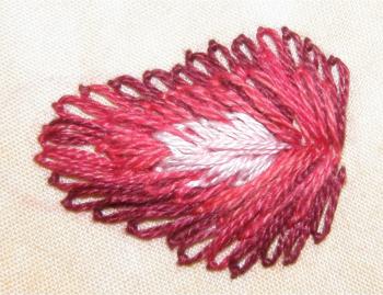 Adding a highlight to the embroidered strawberry design Adding a highlight to the embroidered strawberry design