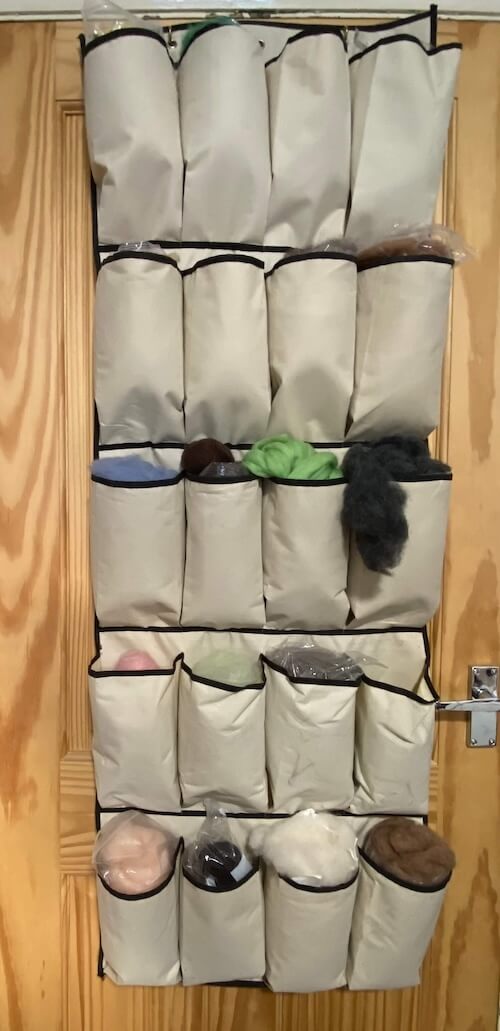 Custom Ikea storage units with labeled bins for efficient sewing room organization.