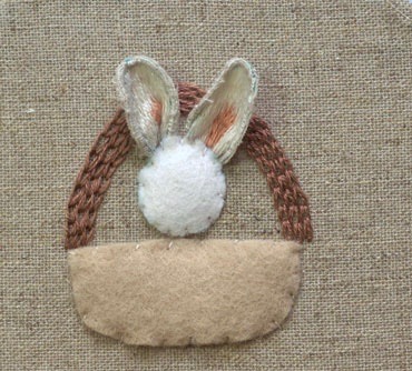 Bunny ears being attached through the fabric with wire ends