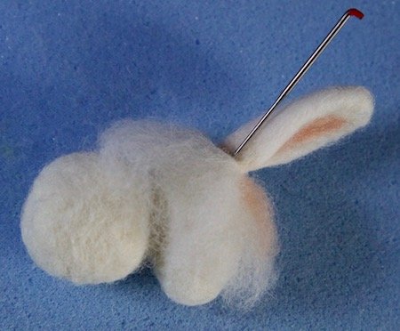 Stabbing the ears onto the bunny's head
