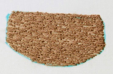 Completed basket slip with couching and edges turned under