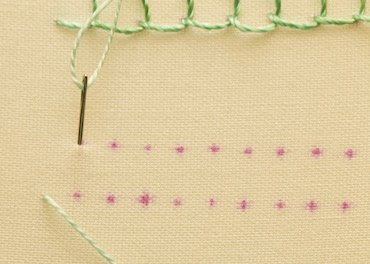 Blanket stitch step 1, bringing the needle up from the back of the fabric