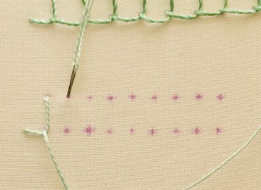 Blanket stitch step 3, needle coming up inside the thread loop