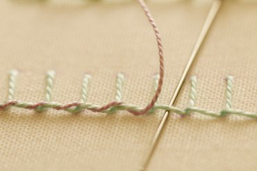 Whipped blanket stitch showing a twisted rope effect along the looped edge
