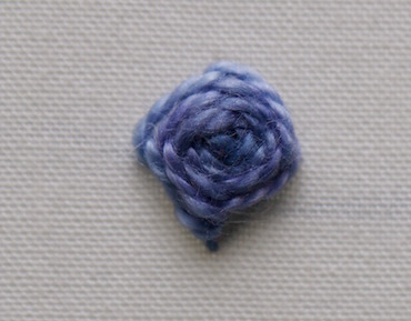 Raised buttonhole stitch flower in blue hand-dyed perle cotton, without guide markings