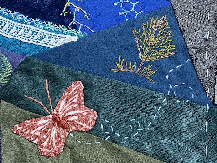 Butterfly appliquéd to the crazy quilt block with a running stitch flight path