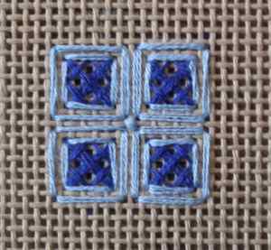 Captive rice stitch showing straight stitches boxing in the crossed corners cross stitches