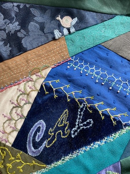 Coral knot stitch letter on a crazy quilt block