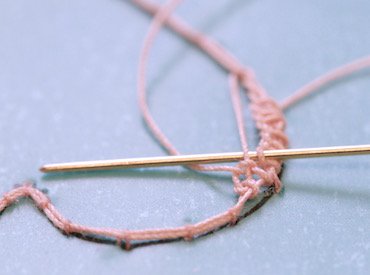 The first half of the heart filled with corded single Brussels stitch