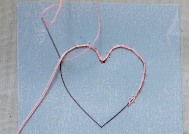Starting a needle lace heart — couching the cordonet outline onto the pad
