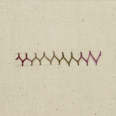 Completed row of Cretan stitch showing where stitches went off the guide lines