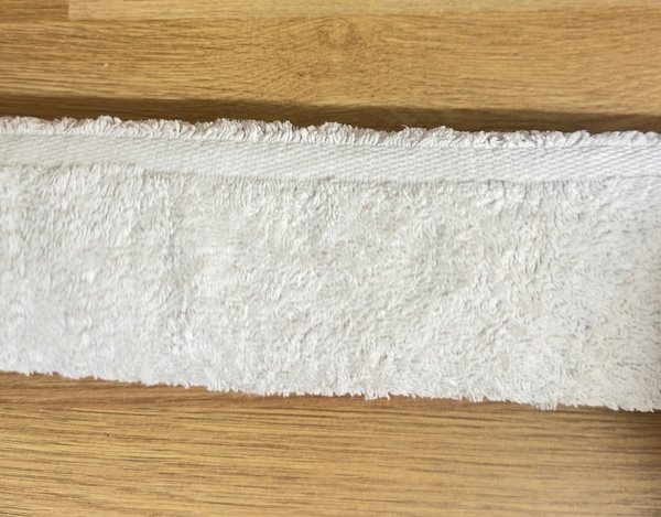 Cross stitch rolled up in towel