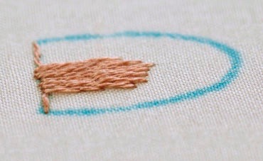 Centre of bunny's ear filled with long and short stitch in peach