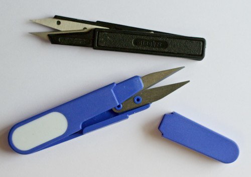 Two different pairs of embroidery snips