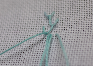 Step 4 in working single feather stitch