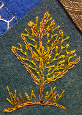 Tree motif worked in feather, chain and straight stitch