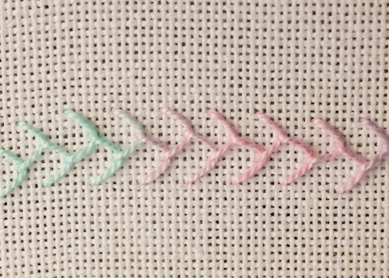 Single feather on evenweave