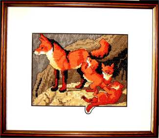 Red fox family counted cross stitch design with cubs at play