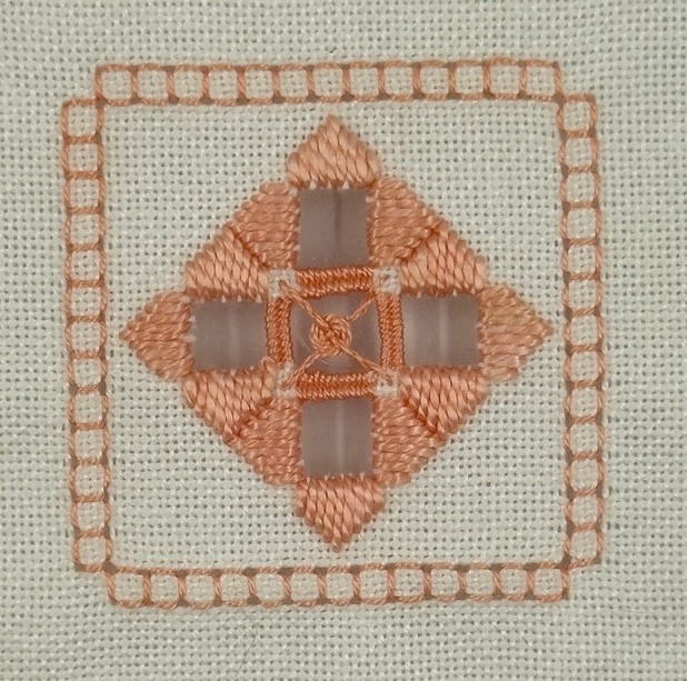 Completed Hardanger coaster worked in peach pearl cotton, featuring fancy Kloster blocks, four-sided stitch border, needleweaving, and spider's web filling