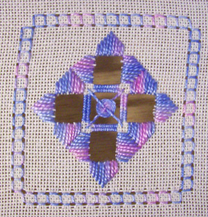 The finished Hardanger coaster from Lesson 4, showing all completed techniques — fancy Kloster blocks, four-sided stitch border, needleweaving, and spider's web filling at the centre