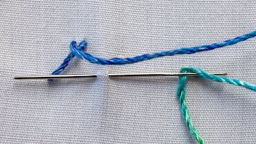 Herringbone stitch step 2 — second stitch crossing over the first