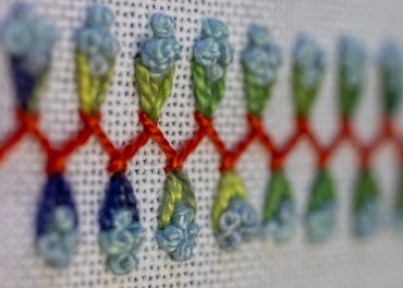 Herringbone stitch with straight stitches and French knots for a floral effect