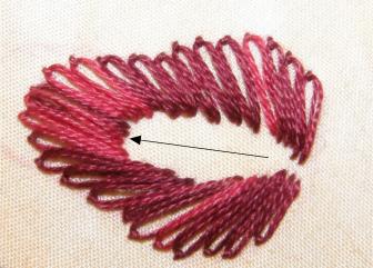 First layer of lazy daisy stitches forming the base of the strawberry