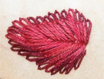 Two layers of lazy daisy stitch completed on the strawberry