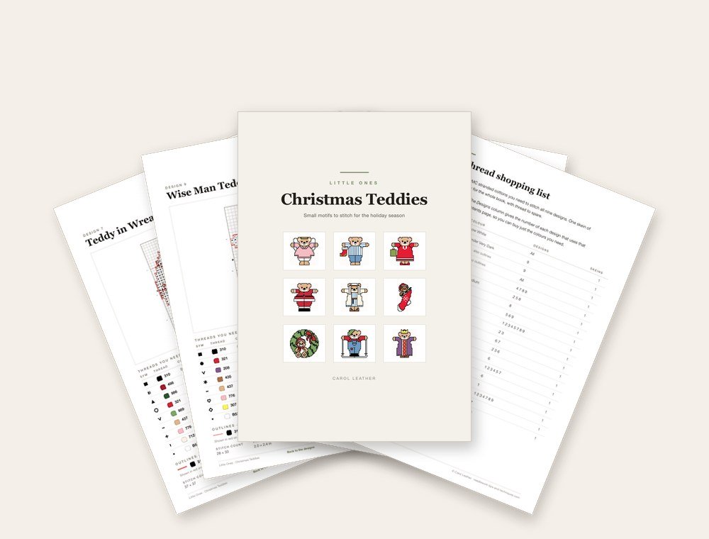 Pages from the Christmas Teddies booklet fanned out, with the cover on top showing nine mini teddy designs