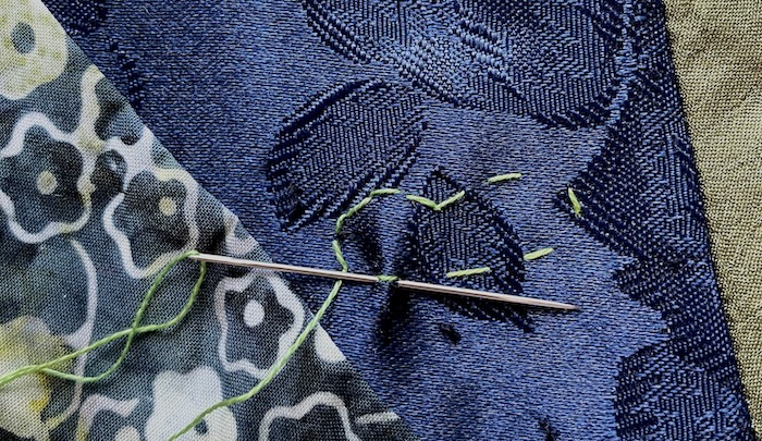 Outlining a lily pad shape with double running stitch