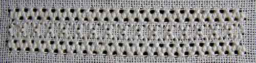 The finished band showing three sided stitch rows framing ringed back stitch