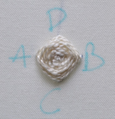 Raised buttonhole stitch flower worked in plain cream perle 8 cotton