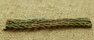 A completed raised stem band showing dimensional texture