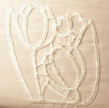 Photo showing the buttonholed outlines of a cutwork design