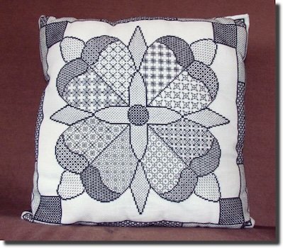 Blackwork Rose Sampler cushion featuring a Tudor rose with geometric petal fills
