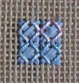 Rice stitch with silk ribbon base and variegated cotton corner stitches