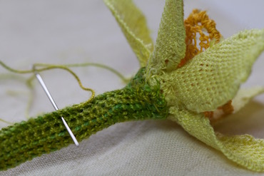 Attaching the stem to the base of the daffodil flower