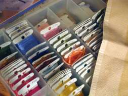 Embroidery floss wound onto bobbins and stored in an organiser box