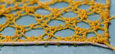 Couching wire to the edge of the trumpet lace